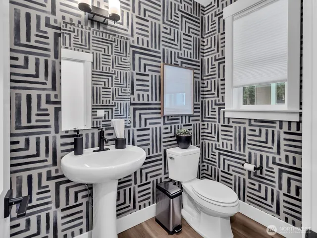 a bathroom with a sink a toilet and mirror