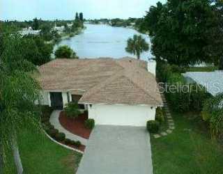 1620 Alton Road Venice, FL 34293 - Photo 1 of 1 a aerial view of a house with a yard and lake view