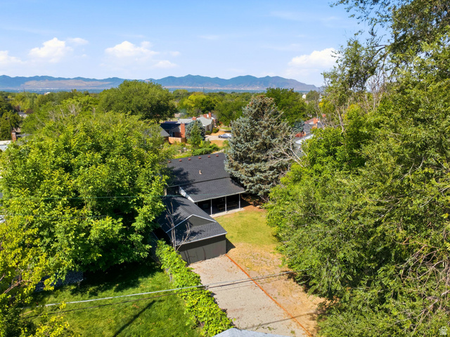 1187 East Ridgedale Circle Millcreek, UT 84106 - Photo 43 of 49 Aerial perspective showcasing a residential property with a detached garage, lush green lawn, and mature trees