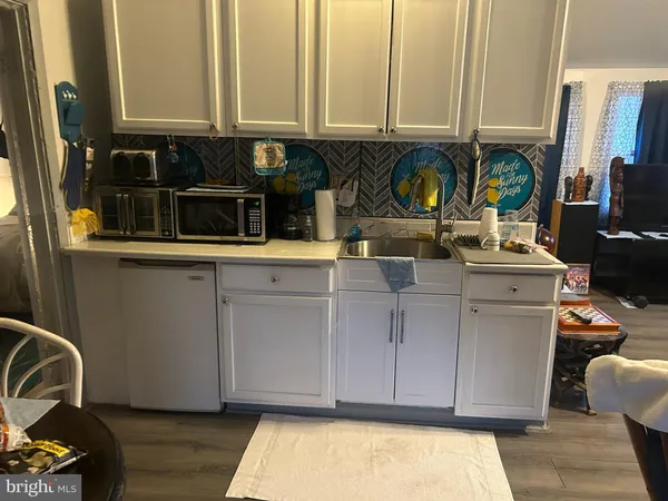 a kitchen with stainless steel appliances granite countertop a sink and a stove