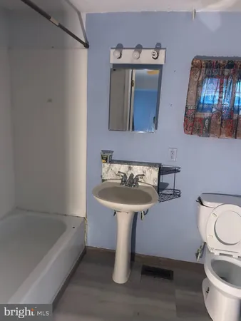 a bathroom with a sink a toilet and bathtub
