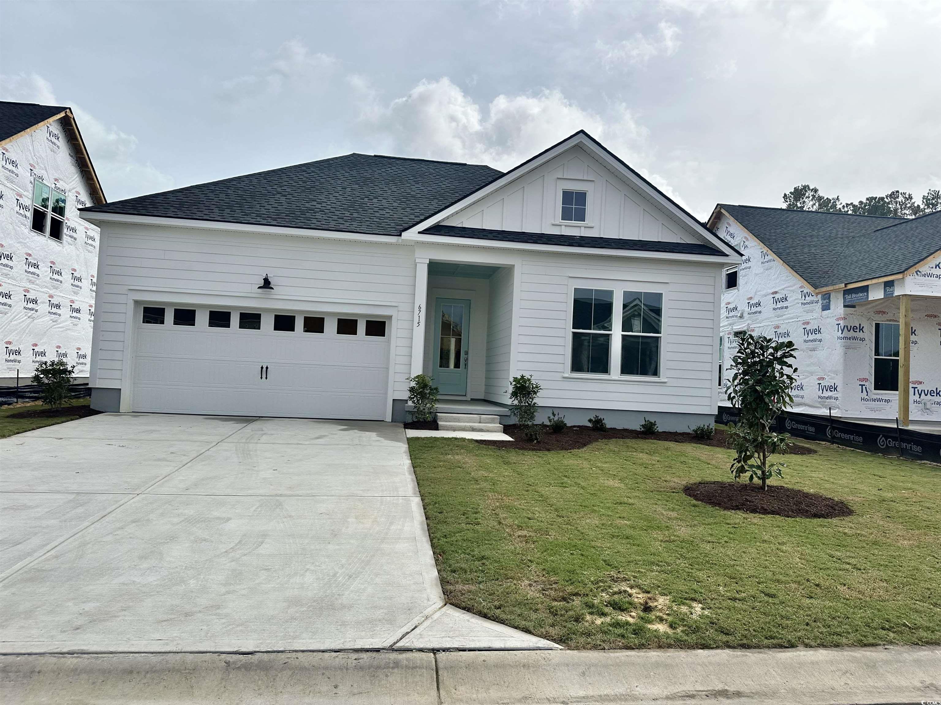 View of front of house with a garage and a front y
