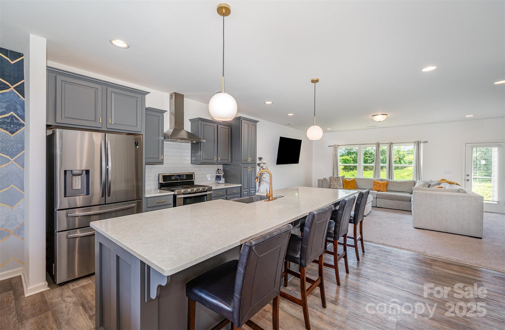 1554 Whitman Court York, SC 29745 - Photo 5 of 21 a kitchen with stainless steel appliances granite countertop a stove a refrigerator a kitchen island a table and chairs