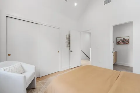 a bedroom with a bed and a couch