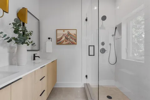 a bathroom with a tub sink and mirror
