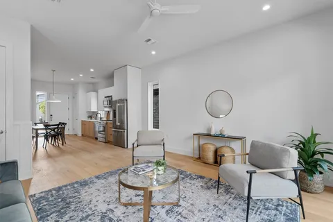 a living room with furniture kitchen view and a table
