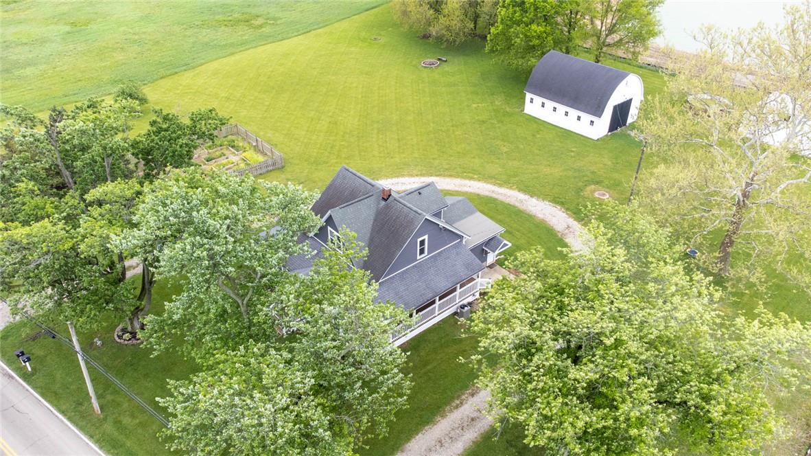 190 Swailes Road Troy, OH 45373 - Photo 51 of 82 This tranquil property boasts a charming house with extensive green spaces and mature trees.