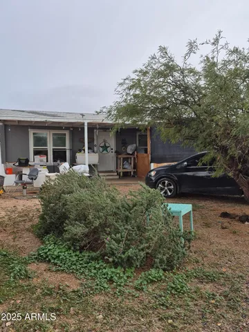 a view of a house with a backyard and sitting area