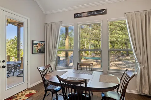a bedroom with a bed and a flat tv screen on dresser
