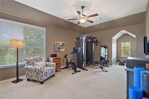 a spacious bedroom with a bed a couch and dresser