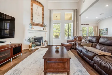 a living room with furniture fireplace and a large window