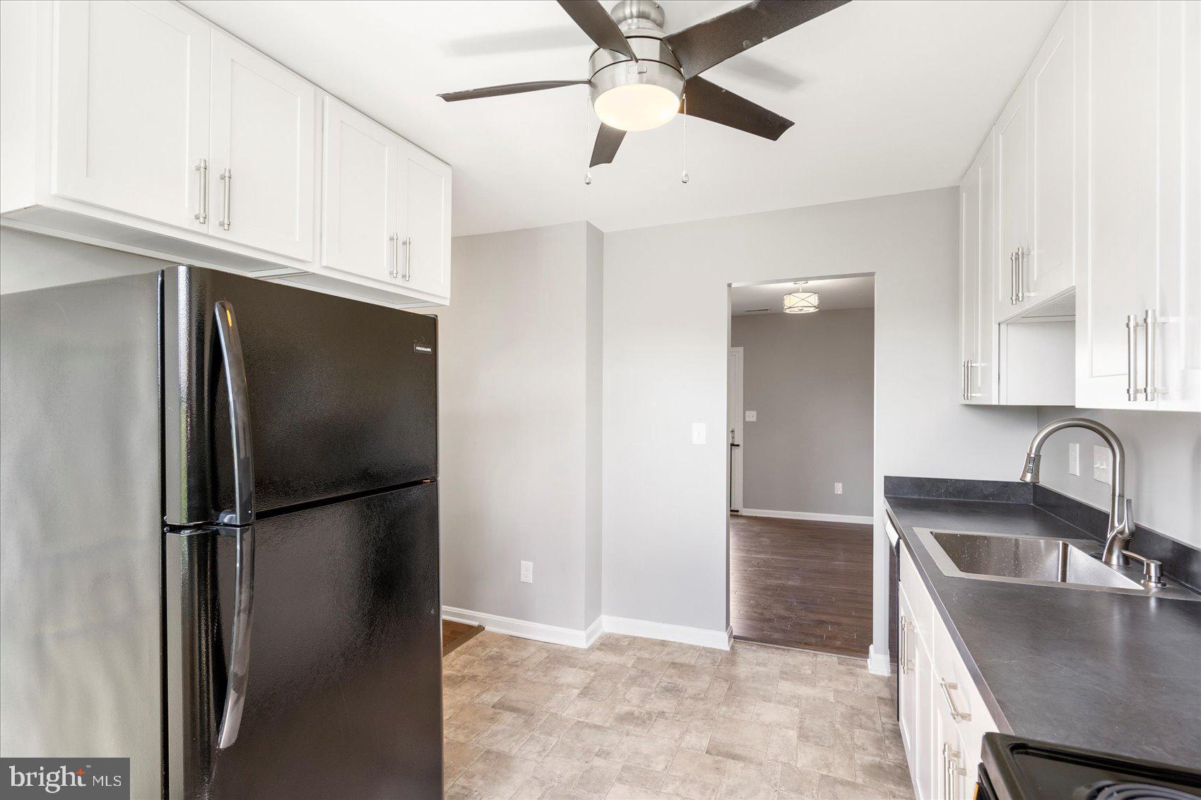 1864 Simons Court Edgewood, MD 21040 - Photo 11 of 28 a kitchen with a refrigerator a sink and cabinets