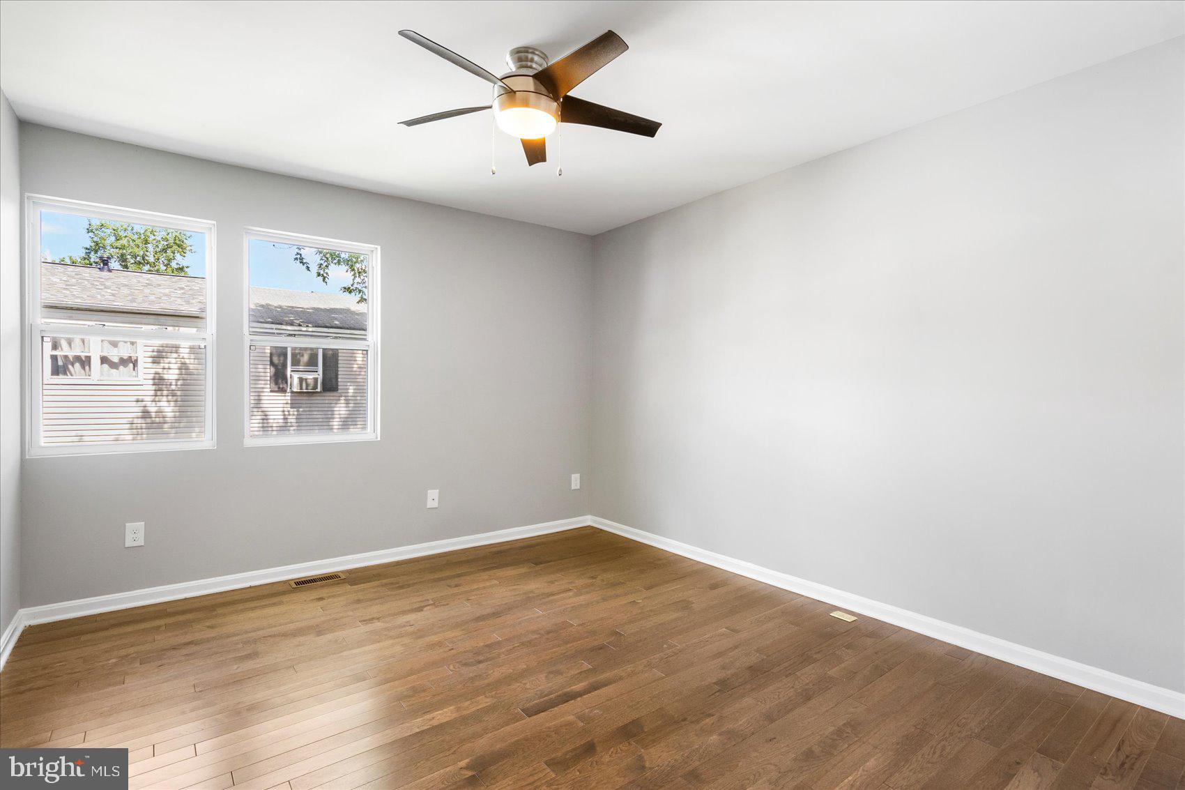 1864 Simons Court Edgewood, MD 21040 - Photo 19 of 28 an empty room with wooden floor and windows