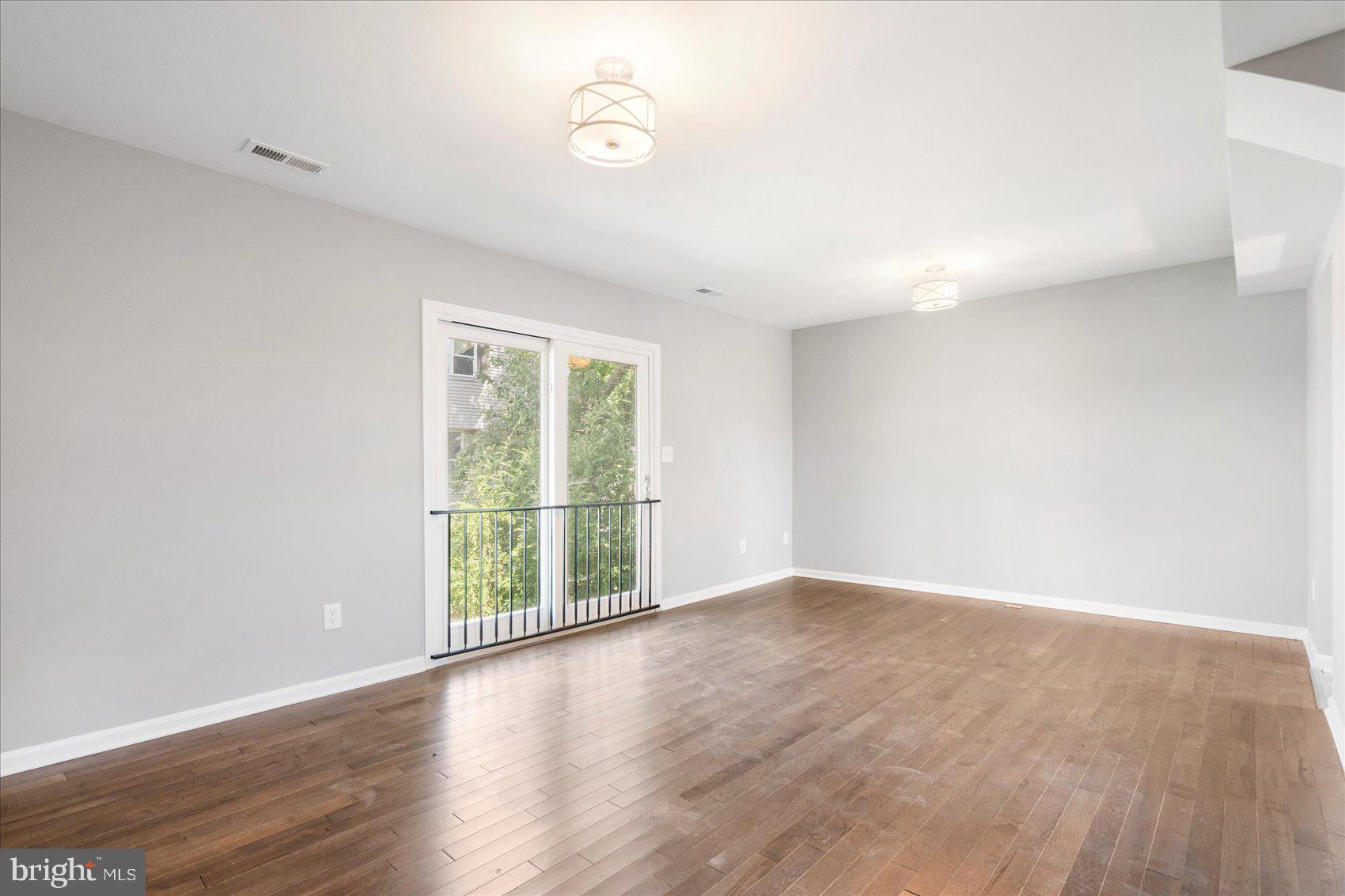 1864 Simons Court Edgewood, MD 21040 - Photo 2 of 28 an empty room with wooden floor and windows