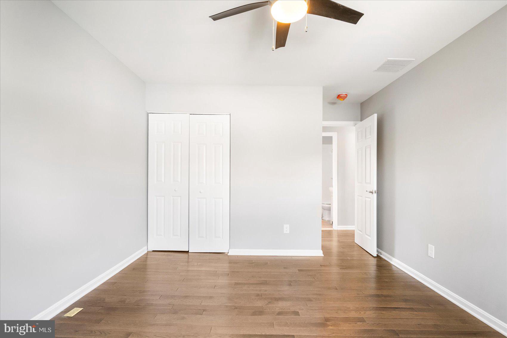 1864 Simons Court Edgewood, MD 21040 - Photo 22 of 28 an empty room with a ceiling fan and wooden floor