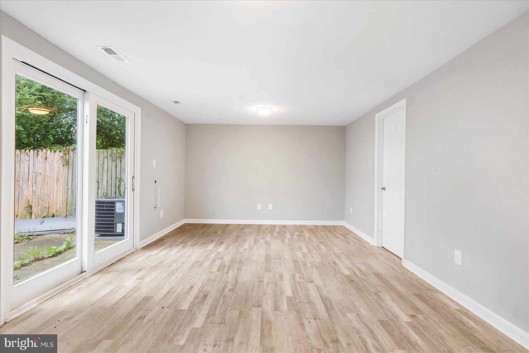1864 Simons Court Edgewood, MD 21040 - Photo 24 of 28 an empty room with wooden floor and windows