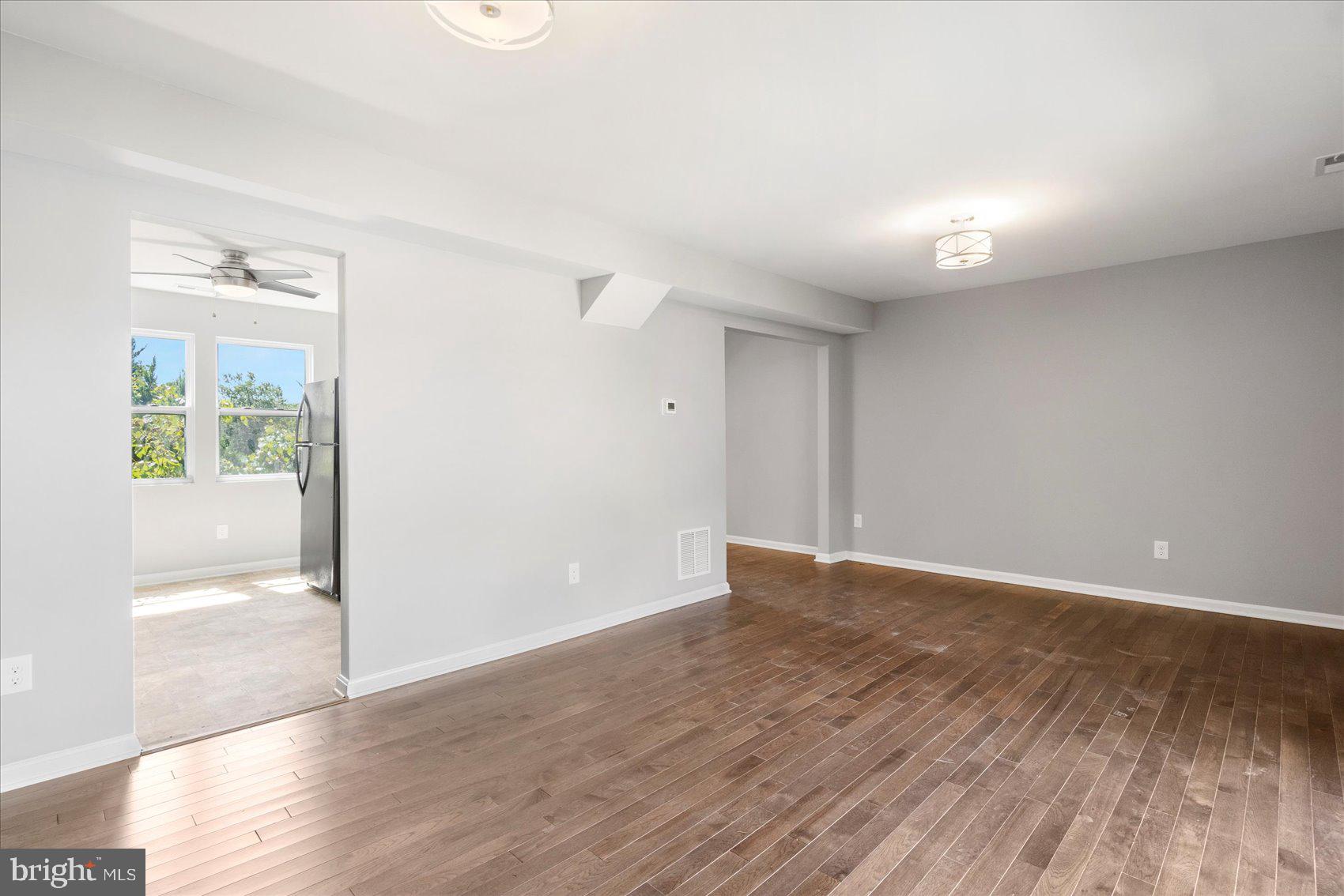 1864 Simons Court Edgewood, MD 21040 - Photo 6 of 28 an empty room with wooden floor and windows