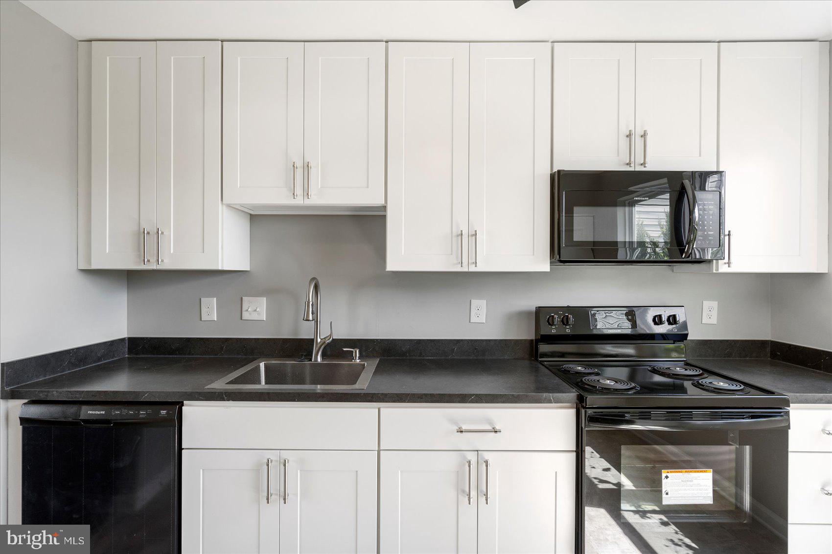 1864 Simons Court Edgewood, MD 21040 - Photo 9 of 28 a kitchen with stainless steel appliances granite countertop white cabinets and a stove top oven