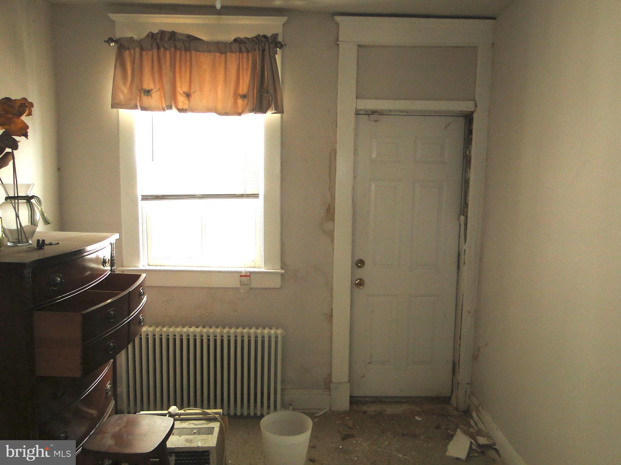 3019 Belair Road Baltimore, MD 21213 - Photo 11 of 11 a bedroom with a bed and a window