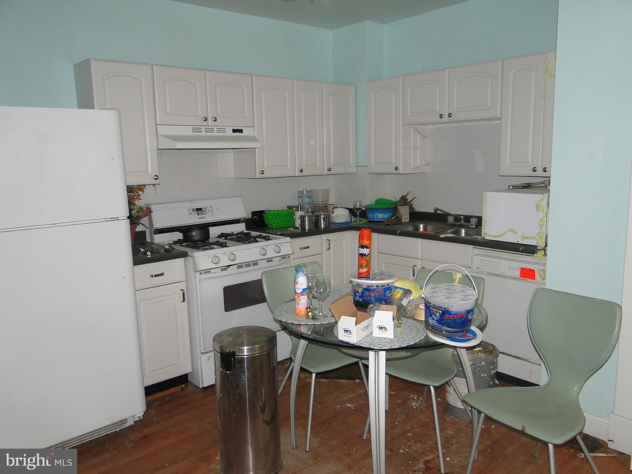 3019 Belair Road Baltimore, MD 21213 - Photo 6 of 11 a kitchen with stainless steel appliances a white table and chairs in it