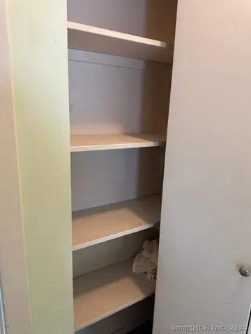 a bathroom with a toilet and white door