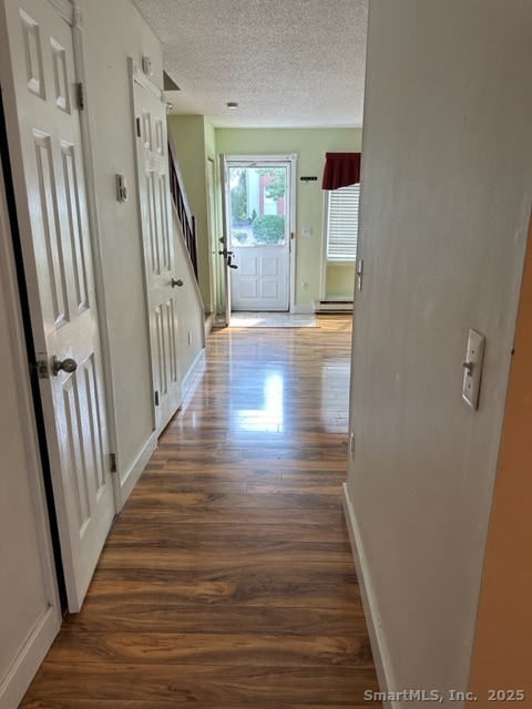 585 Park Road, Unit 108 Waterbury, CT 06708 - Photo 4 of 13 a view of a hallway with wooden floor and stairs
