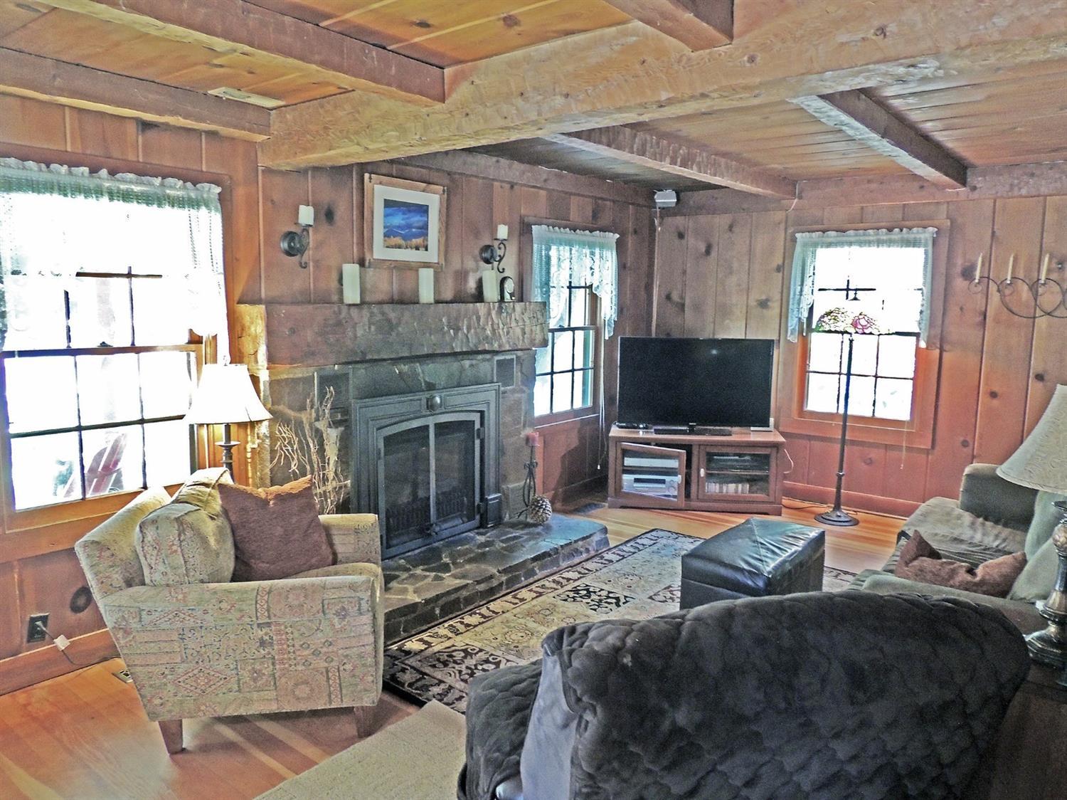 765 Old Ferry Road Shady Cove, OR 97539 - Photo 8 of 32 Living room with hand-hewn beams and man