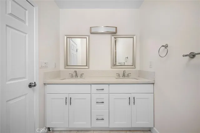 a bathroom with cabinets granite and a sink