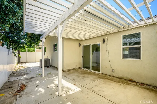 a view of a porch with a table and chairs and potted plants