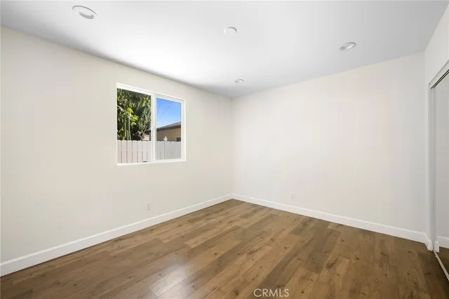 a view of a room with wooden floor and white walls