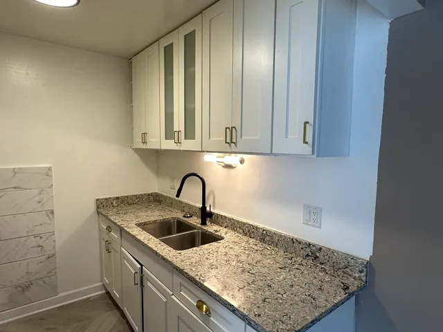 a kitchen with a sink and cabinets
