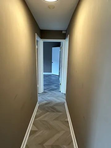a view of hallway with wooden floor