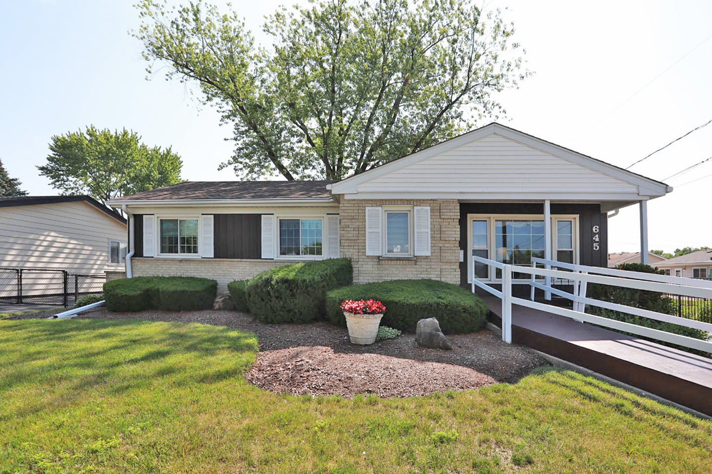 645 South Ardmore Avenue Addison, IL 60101 - Photo 1 of 28 a front view of a house with a yard table and chairs