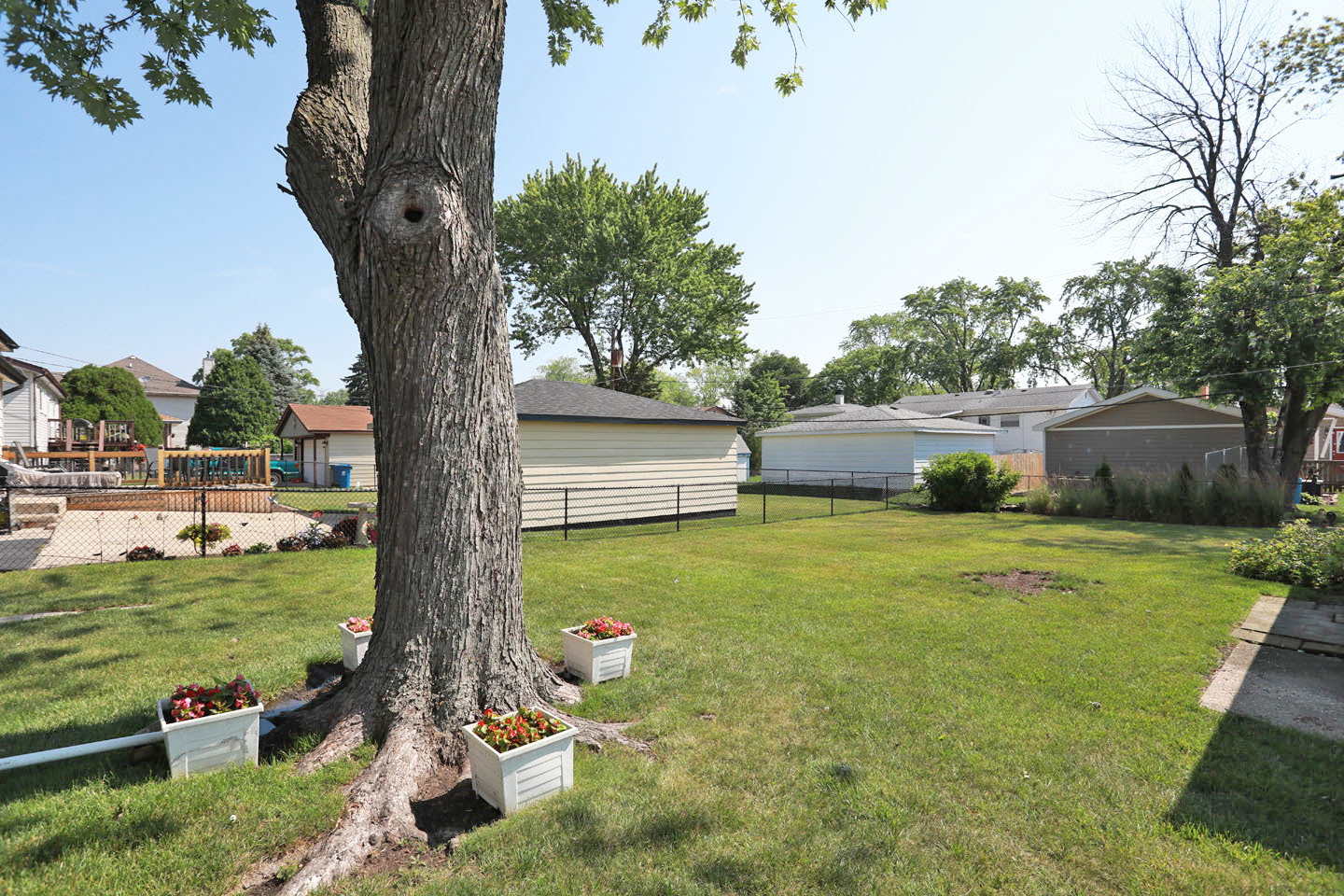 645 South Ardmore Avenue Addison, IL 60101 - Photo 25 of 28 a backyard of a house with lots of green space and fountain