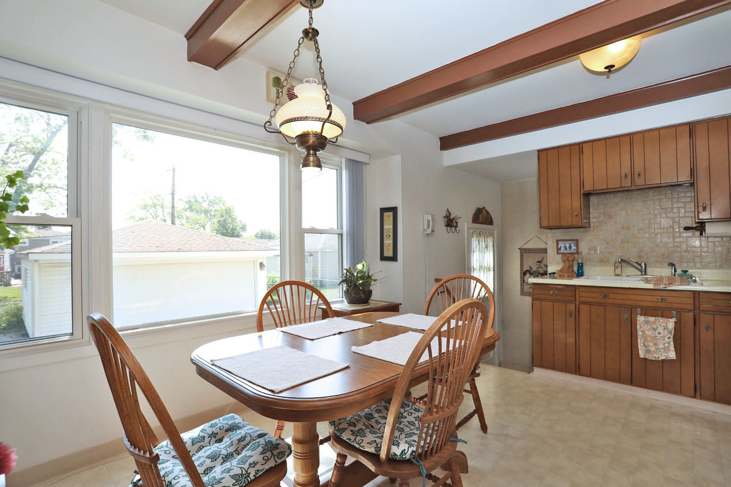 645 South Ardmore Avenue Addison, IL 60101 - Photo 8 of 28 a dining room with furniture a chandelier and window
