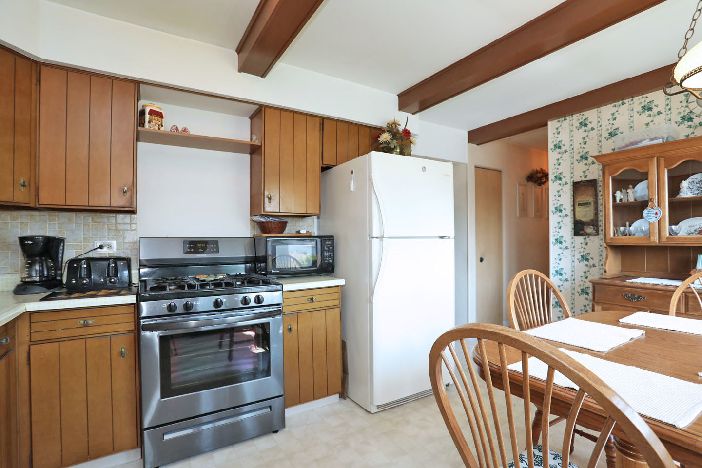 645 South Ardmore Avenue Addison, IL 60101 - Photo 10 of 28 a kitchen with stainless steel appliances a stove a sink and a refrigerator