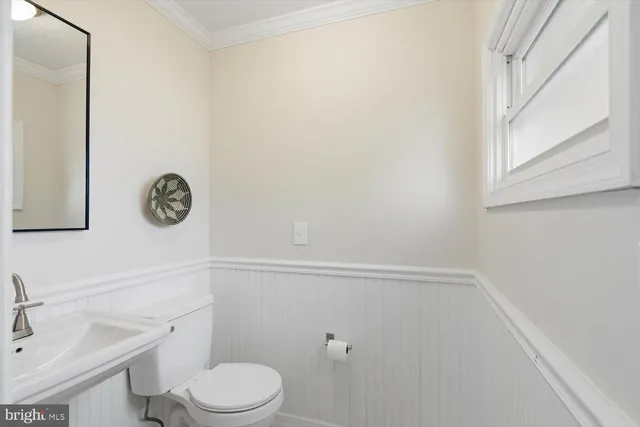 a white toilet sitting next to a bathroom sink