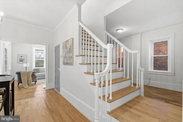 a view of entryway with wooden floor and stairs