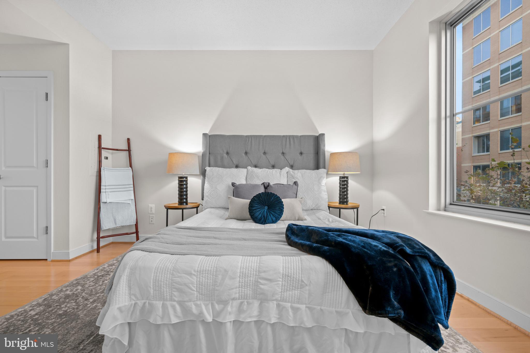 820 North Pollard Street, Unit 307 Arlington, VA 22203 - Photo 16 of 29 a bedroom with a bed and a fireplace