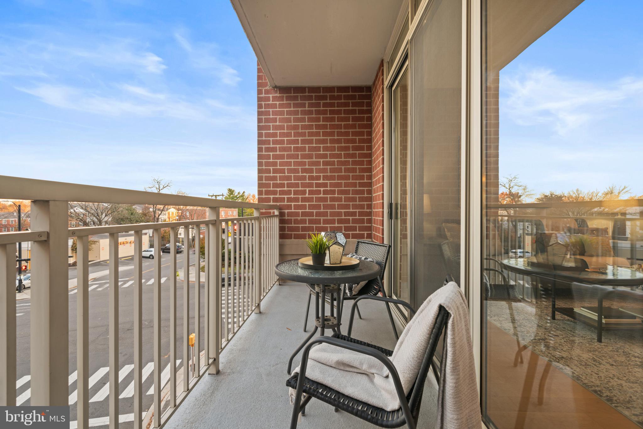 820 North Pollard Street, Unit 307 Arlington, VA 22203 - Photo 23 of 29 a balcony with a water view and table and chairs