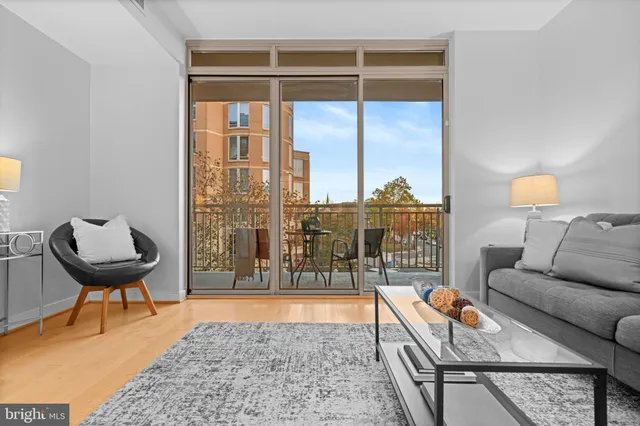 a living room with furniture and a floor to ceiling window