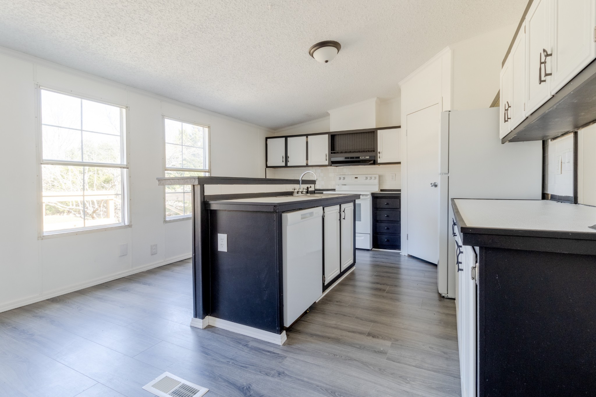 1835 Jim Kim Road Palmyra, TN 37142 - Photo 11 of 36 a kitchen with stainless steel appliances granite countertop a stove cabinets and wooden floor