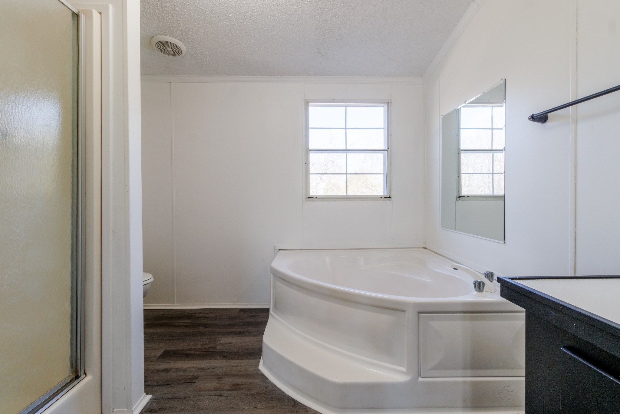 1835 Jim Kim Road Palmyra, TN 37142 - Photo 17 of 36 a white bath tub sitting in a bathroom next to a window