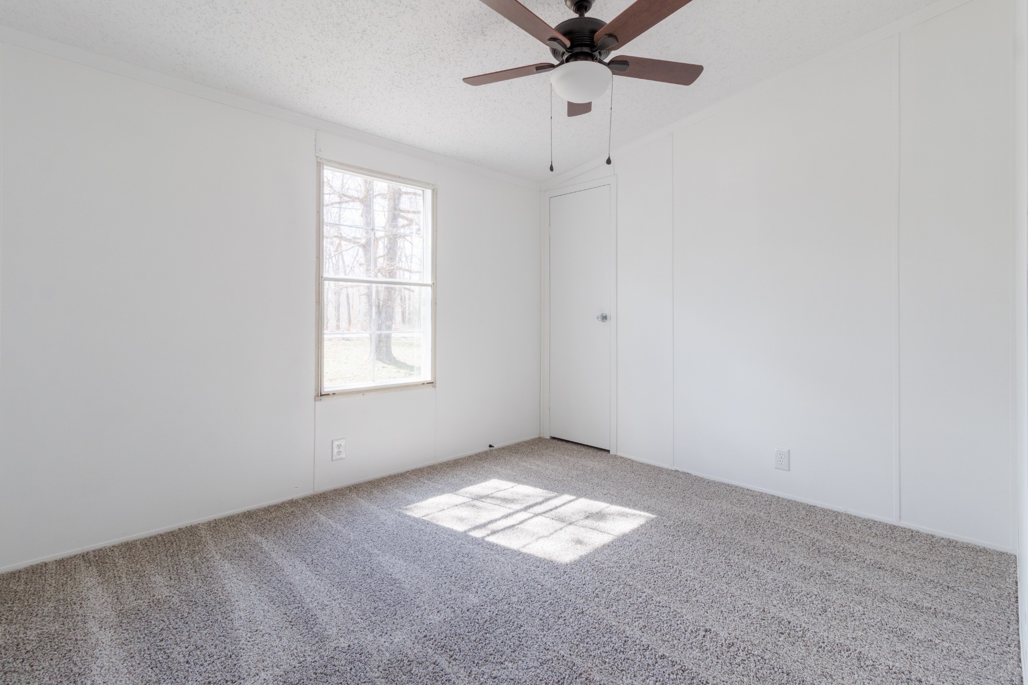 1835 Jim Kim Road Palmyra, TN 37142 - Photo 18 of 36 an empty room with a window and a fan