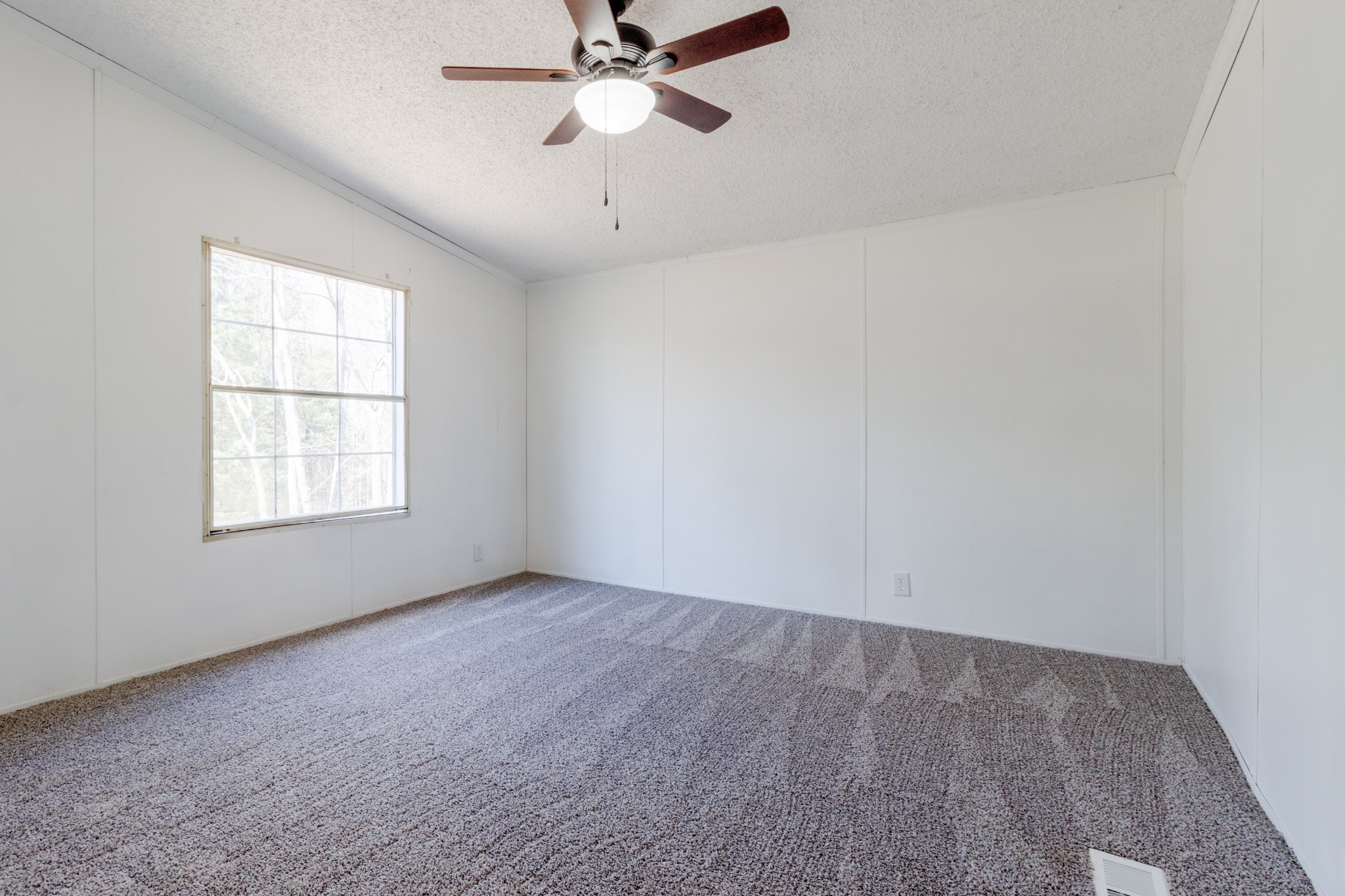 1835 Jim Kim Road Palmyra, TN 37142 - Photo 21 of 36 an empty room with a window and a fan