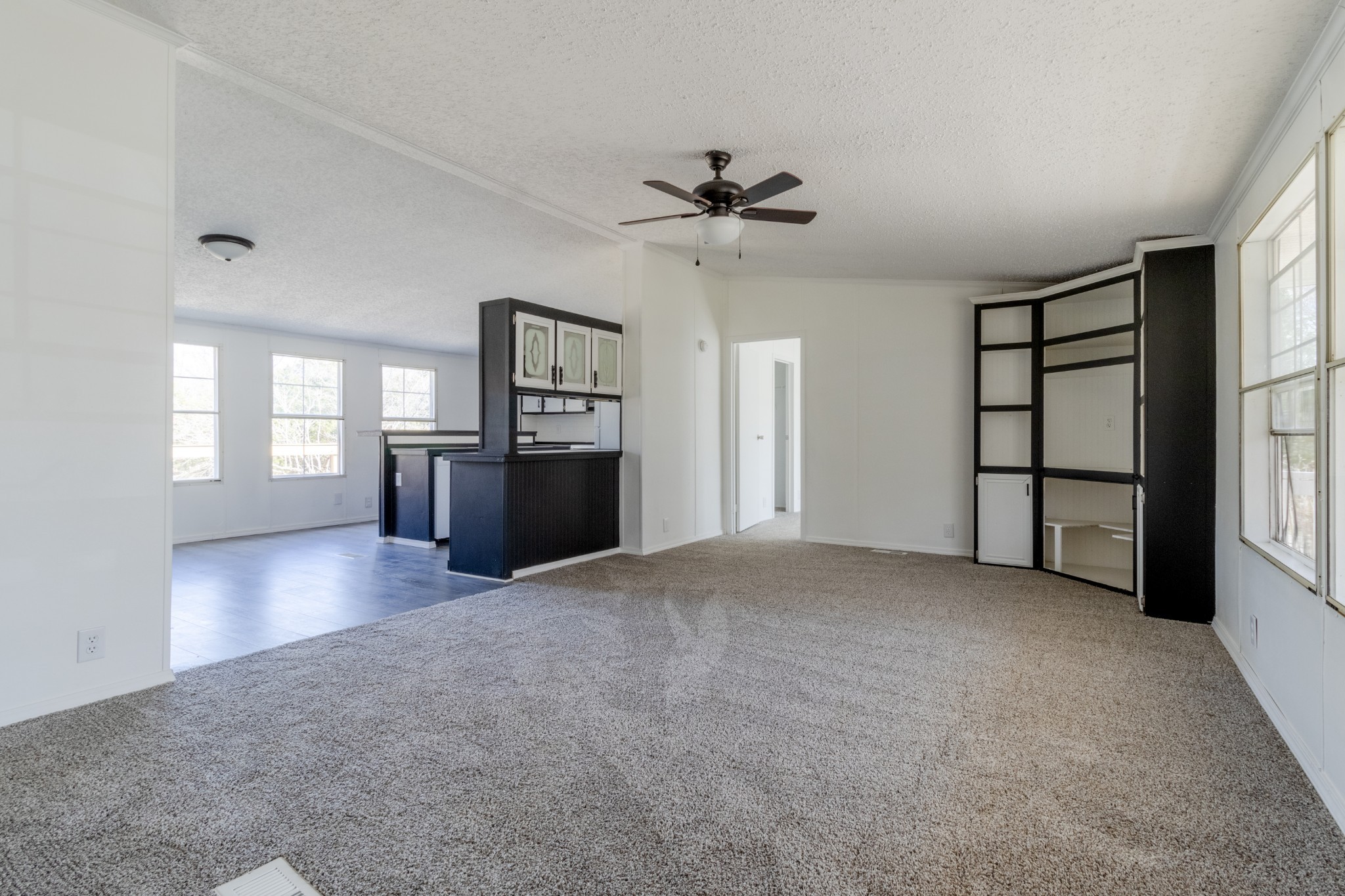 1835 Jim Kim Road Palmyra, TN 37142 - Photo 4 of 36 a view of an empty room with a window and a kitchen