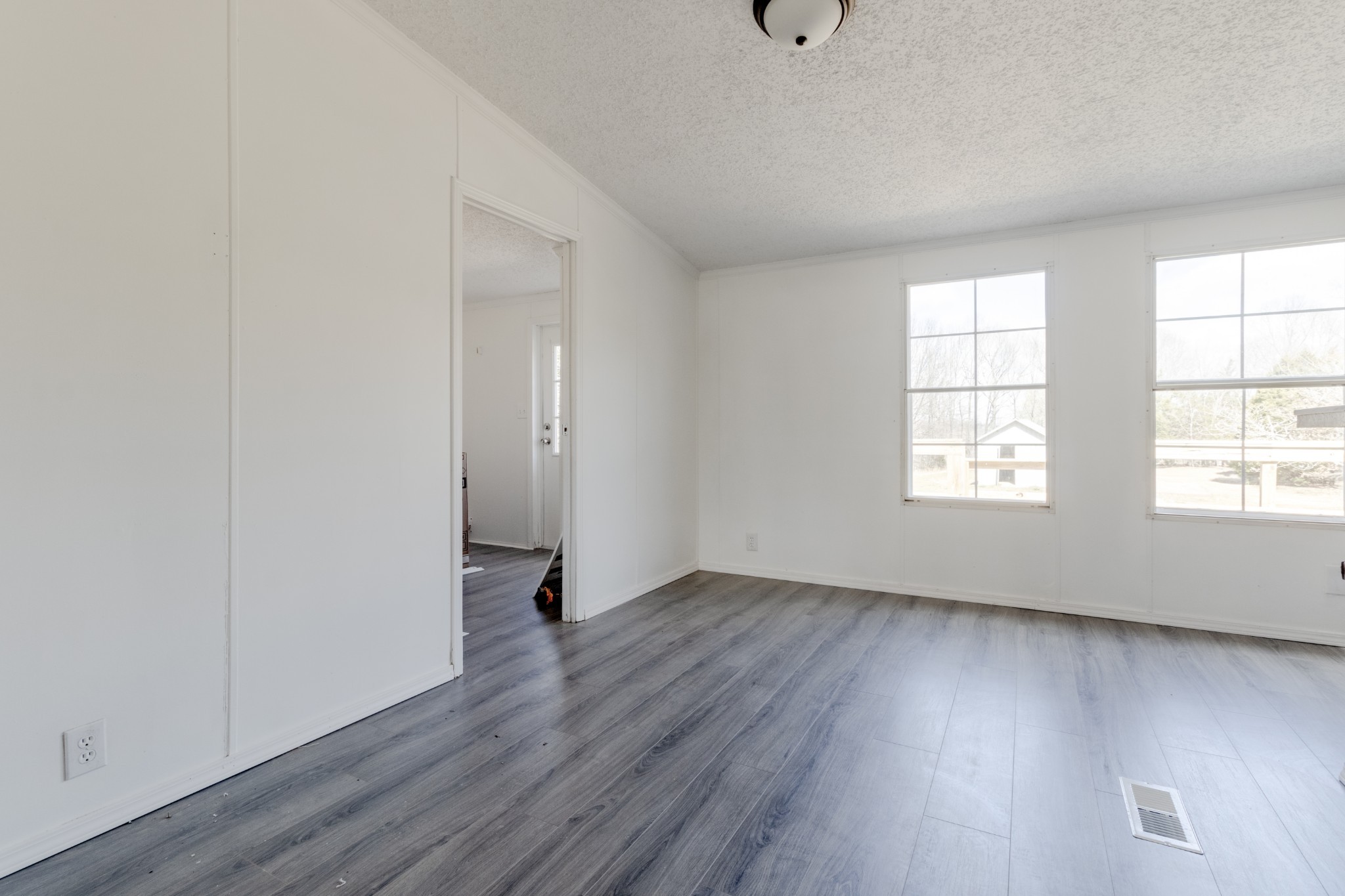 1835 Jim Kim Road Palmyra, TN 37142 - Photo 7 of 36 an empty room with wooden floor and windows
