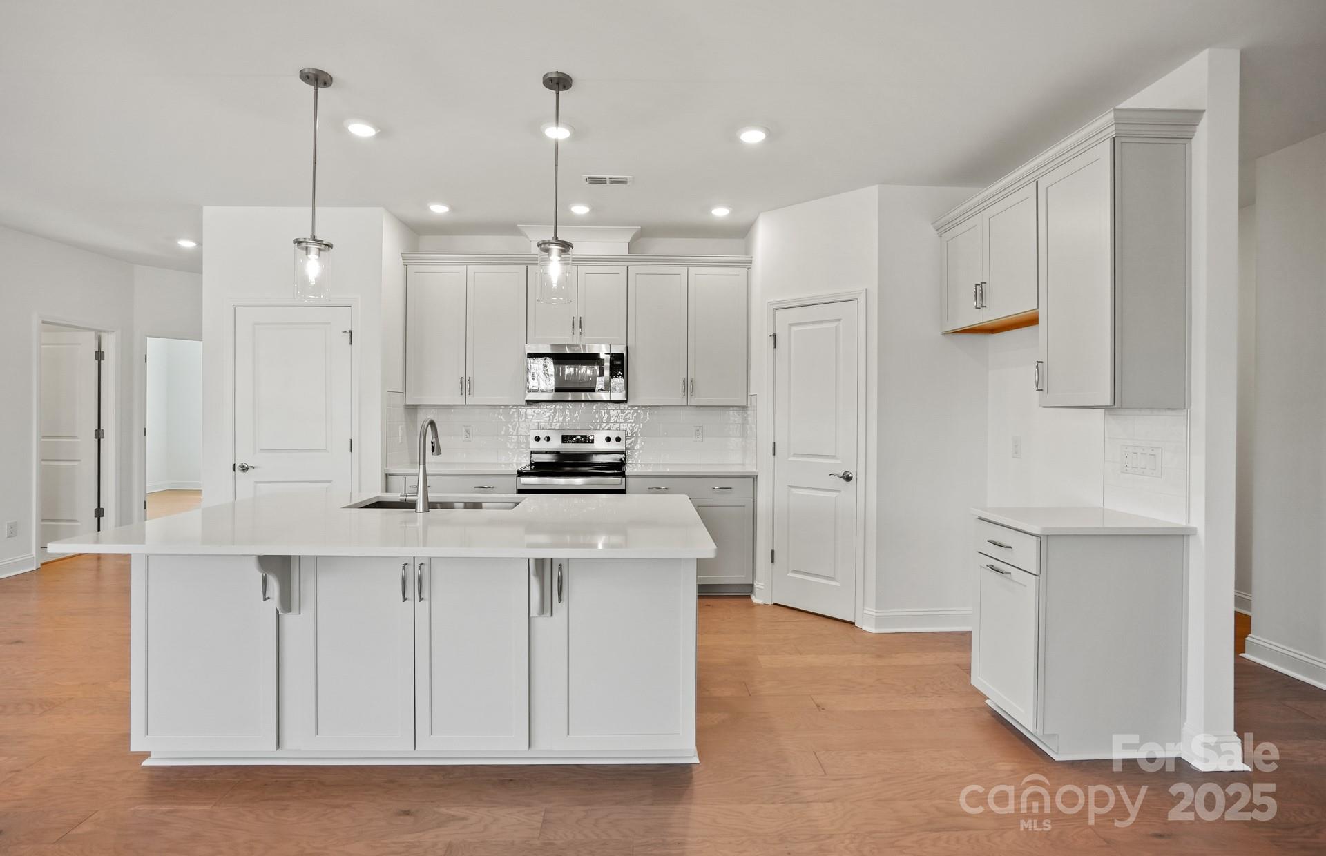 2234 Millenium Drive, Unit 84 Lancaster, SC 29720 - Photo 14 of 37 a kitchen with white cabinets and refrigerator