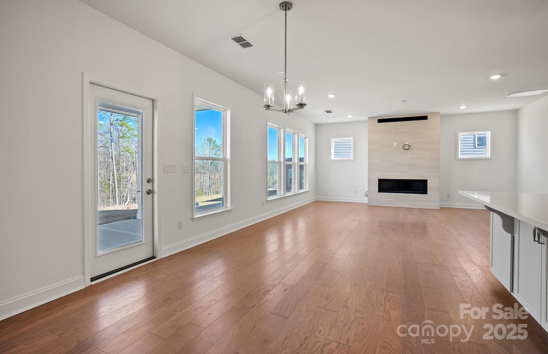 2234 Millenium Drive, Unit 84 Lancaster, SC 29720 - Photo 18 of 37 a view of a livingroom with wooden floor and a ceiling fan