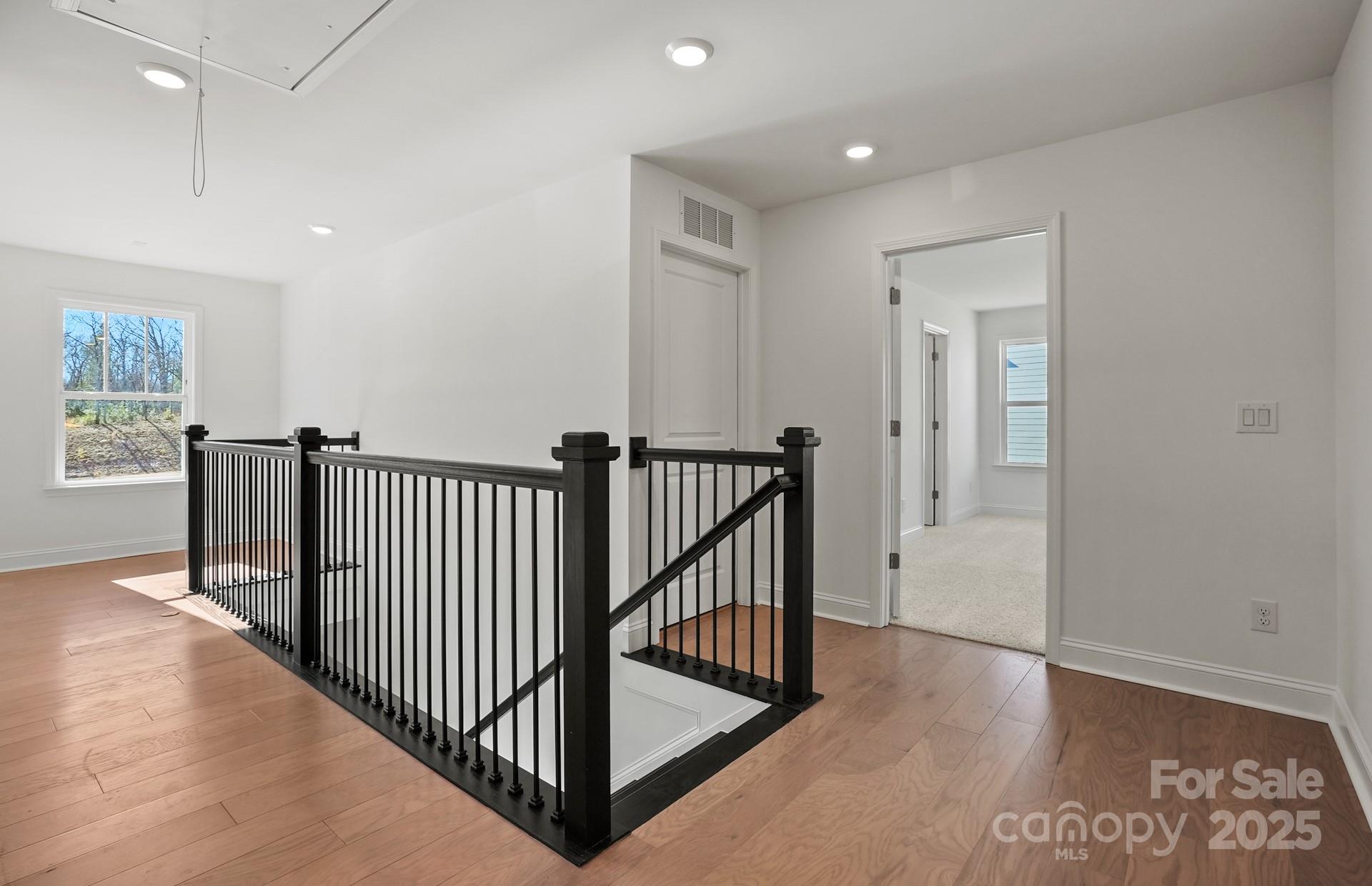 2234 Millenium Drive, Unit 84 Lancaster, SC 29720 - Photo 21 of 37 a view of a hallway with wooden floor and windows